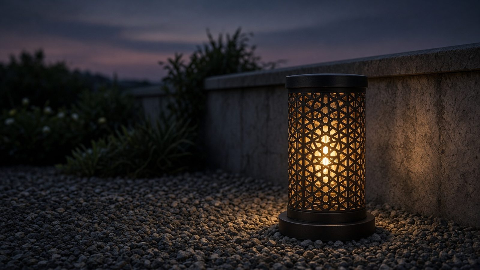 Lattice metal bollard glowing beside a compound wall at night